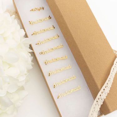 Gold 'Bridesmaid' sash on a white background with lace and flowers.