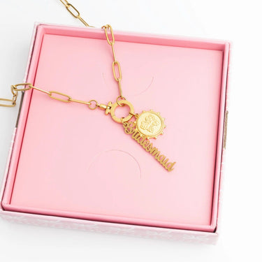 Gold bracelet with 'Bridesmaid' charm in a pink box