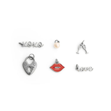 Collection of various silver charms on a white background