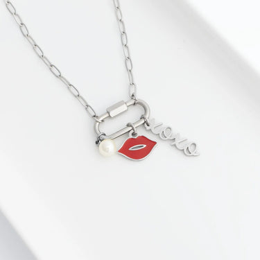 Necklace with lip-shaped charm, pearl, and 'love' pendant on a white background