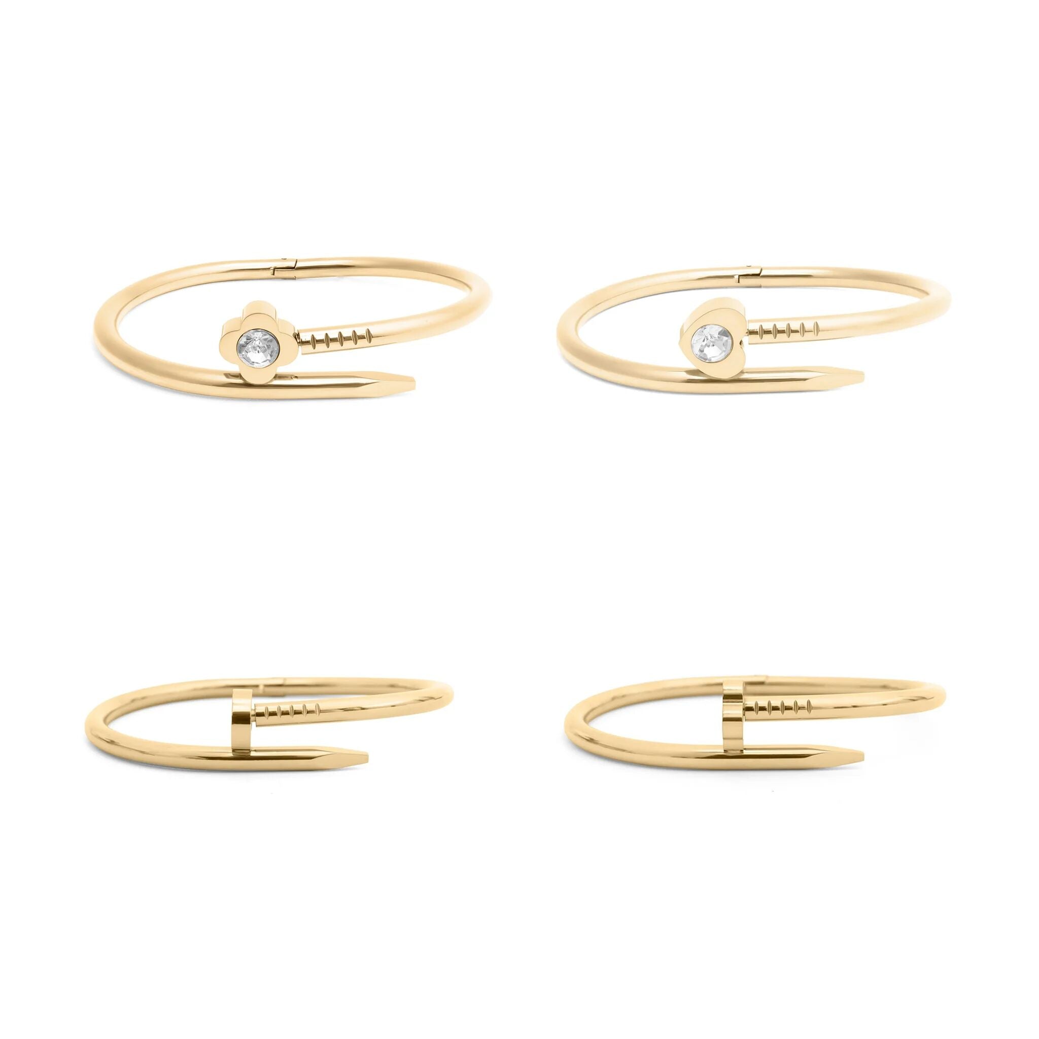 Set of four gold nail bangle bracelets with small gemstones on a white background
