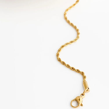 Gold bracelet with a clasp on a white background