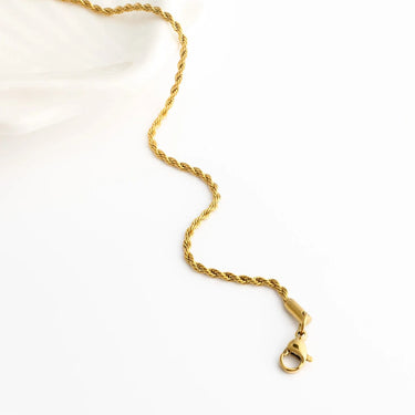 Gold chain necklace on a white background