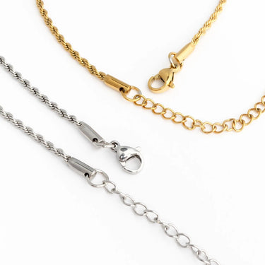 Two gold and silver chains with clasp mechanisms on a white background
