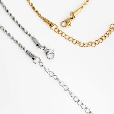 Three gold, silver, and stainless steel chains on a white background