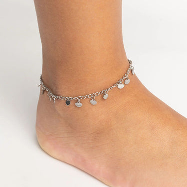 Silver Dangle Hearts Anklet with heart-shaped charms on a foot against a white background