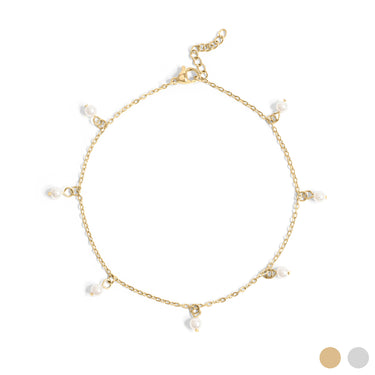 A gold-colored stainless steel anklet with white pearls attached to it, presented against a white background with a shadowed image of the anklet below.