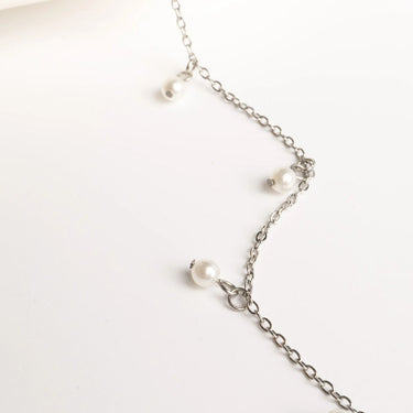 Pearl necklace with silver chain on a white background