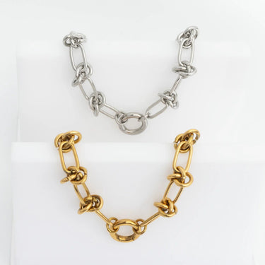 Gold and silver chain necklaces on a white background