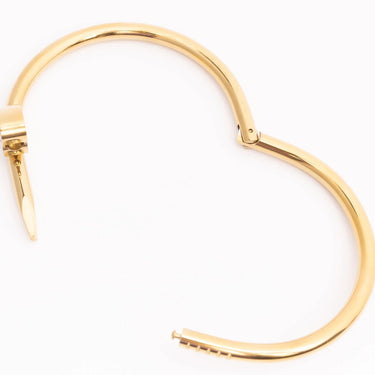Gold hoop earring on a white background
