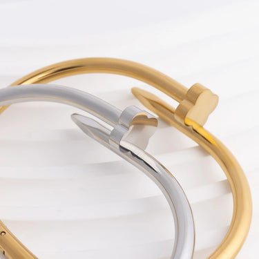 Close-up of a gold and silver bracelet on a light background