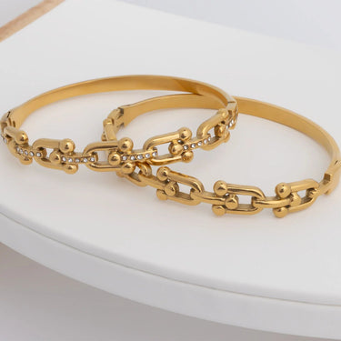 Gold chain bracelet on a white surface