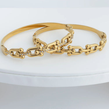 Gold chain bracelet on a white surface
