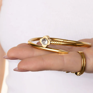 Gold bracelet with a diamond on a white background