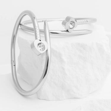 Silver bracelet with heart-shaped charms on a white background