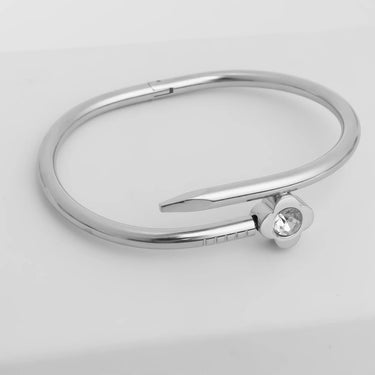 Silver bracelet with a small round gemstone on a light gray background