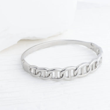 Silver ring with a textured band on a white background