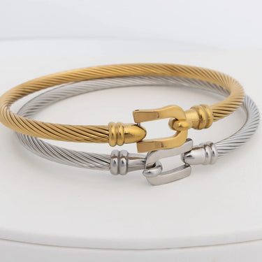 Gold and silver buckle clasp bracelet on a white background