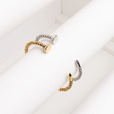 Gold and silver nose ring on a white background