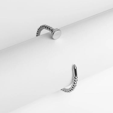 Silver ring with a textured band on a white background