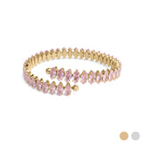 Gold bracelet with pink gemstones on a white background