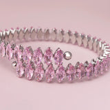 Silver headband with pink gemstones on a pink background