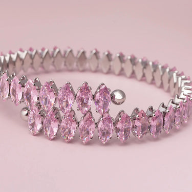 Silver headband with pink gemstones on a pink background