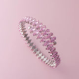 Pink and silver bracelet on a pink background