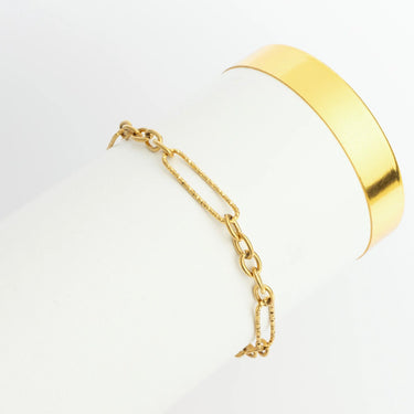 Gold bracelet with a chain on a white background