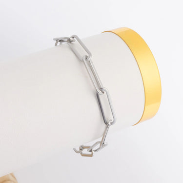 Bracelet with a yellow band and silver clasp on a white background