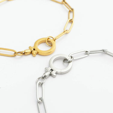 Gold and silver chain bracelets on a white background