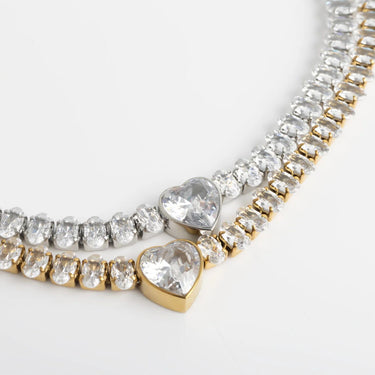 Jewelry with heart-shaped gemstones on a light gray background