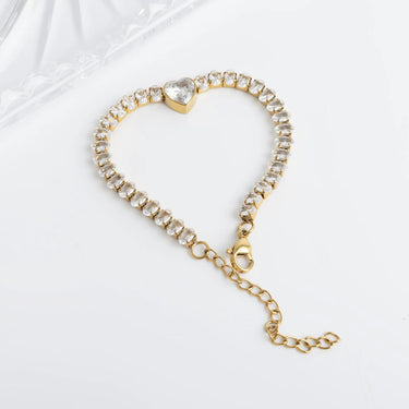 Gold bracelet with heart-shaped clasp on a white background