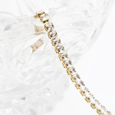 Gold and clear crystal bracelet on a white background