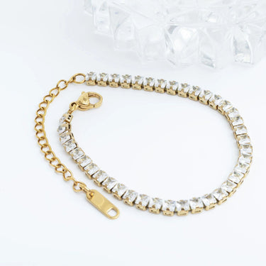 Gold bracelet with clear crystals on a white background