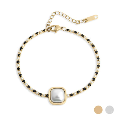 Gold bracelet with a central pearl and black stones on a white background
