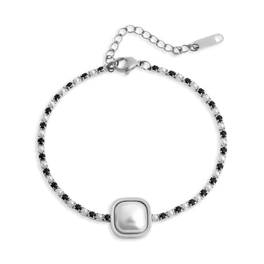 Silver bracelet with a central pearl-like bead on a white background
