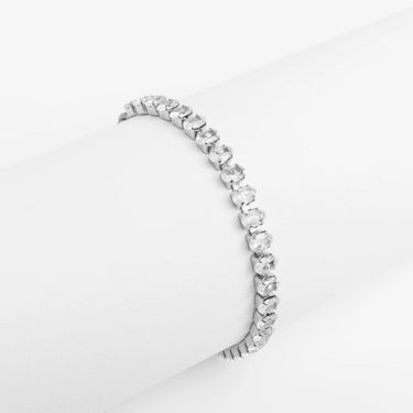 Silver bracelet with clear stones on a light gray background