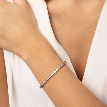 Bracelet on a person's wrist with a white background
