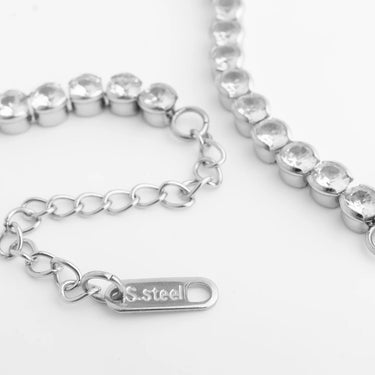 Silver beaded bracelet with a chain link and 'S. Steel' tag on a white background