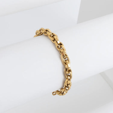 Gold chain bracelet on a white surface