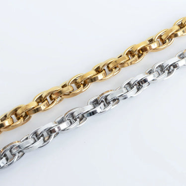 Gold and silver chain links on a white background