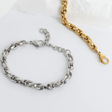 Silver and gold chain bracelets on a white background