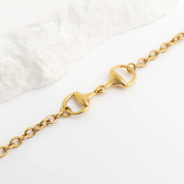 Gold chain Horsebit Bracelet on a white background