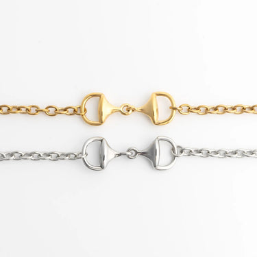 Two gold and silver horse bit bracelets on a white background
