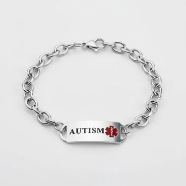 Silver chain bracelet with an autism medical alert tag on a white background