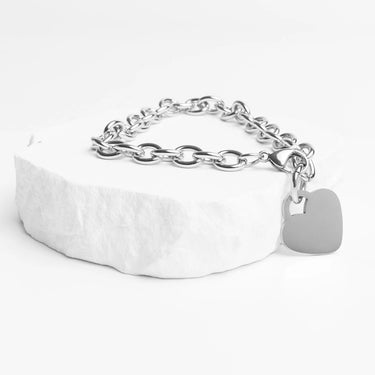 Silver chain bracelet with a tag on a white background