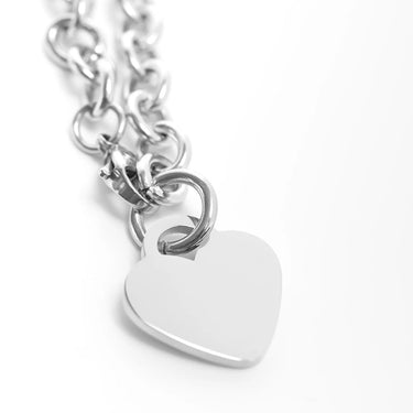 Silver chain bracelet with a heart-shaped tag on a white background