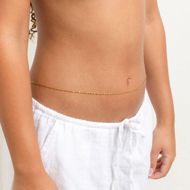 Person wearing a gold Singapore Belly Chain around their waist with a plain background