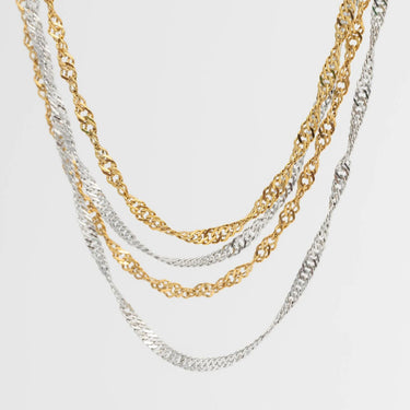 Two gold and silver chain Singapore Belly Chains on a light gray background